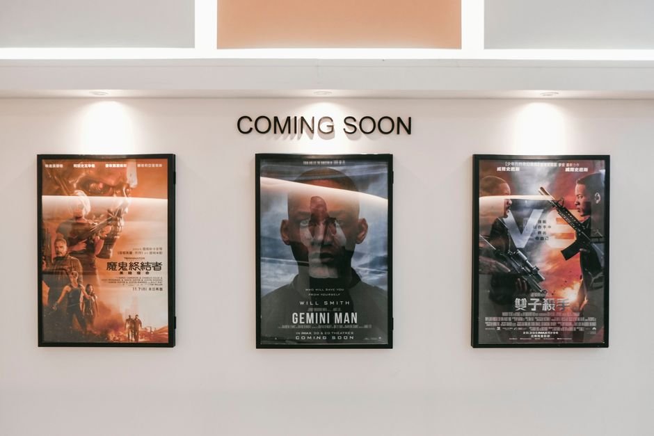 Vietnamese Horror Film ‘Bloodline: The Curse Within’ Set for International Market Debut Framed posters of upcoming movies in a cinema hallway under 'Coming Soon' sign.
