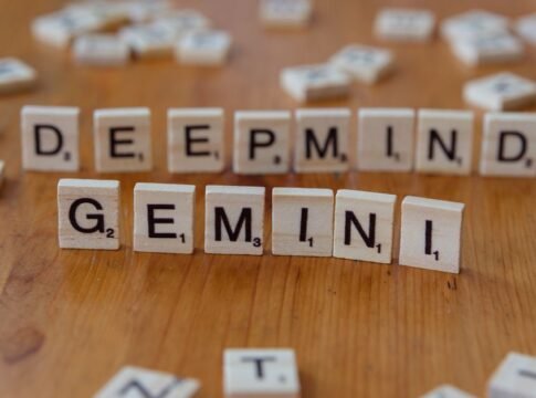 Wooden Scrabble tiles spelling 'Deepmind' and 'Gemini' on a wooden surface, a concept of AI and games. Wooden Scrabble tiles spelling 'Deepmind' and 'Gemini' on a wooden surface, a concept of AI and games.